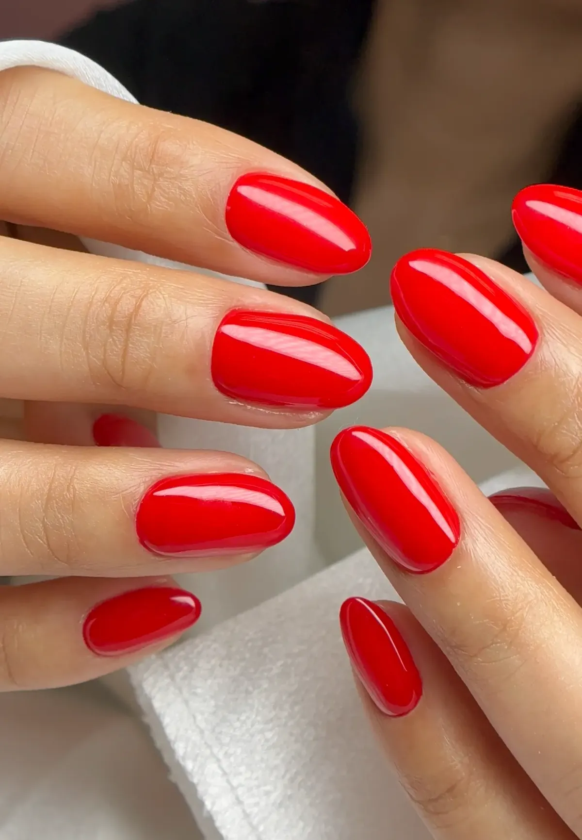 Glossy red almond gel nails by Polished by Kim in The Woodlands TX