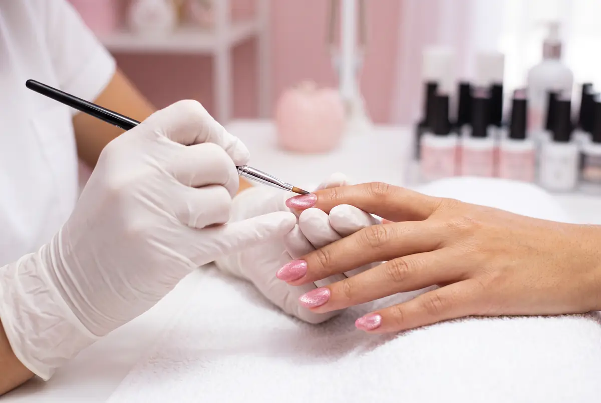 Nail technician carefully applying gel at Polished by Kim The Woodlands TX