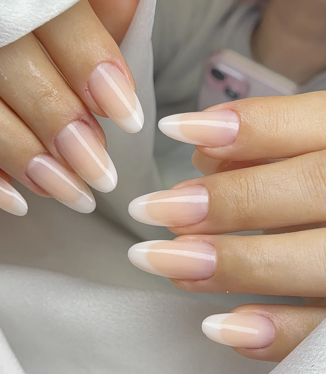 Classic French manicure on almond nails with pink base and white tips by Polished by Kim