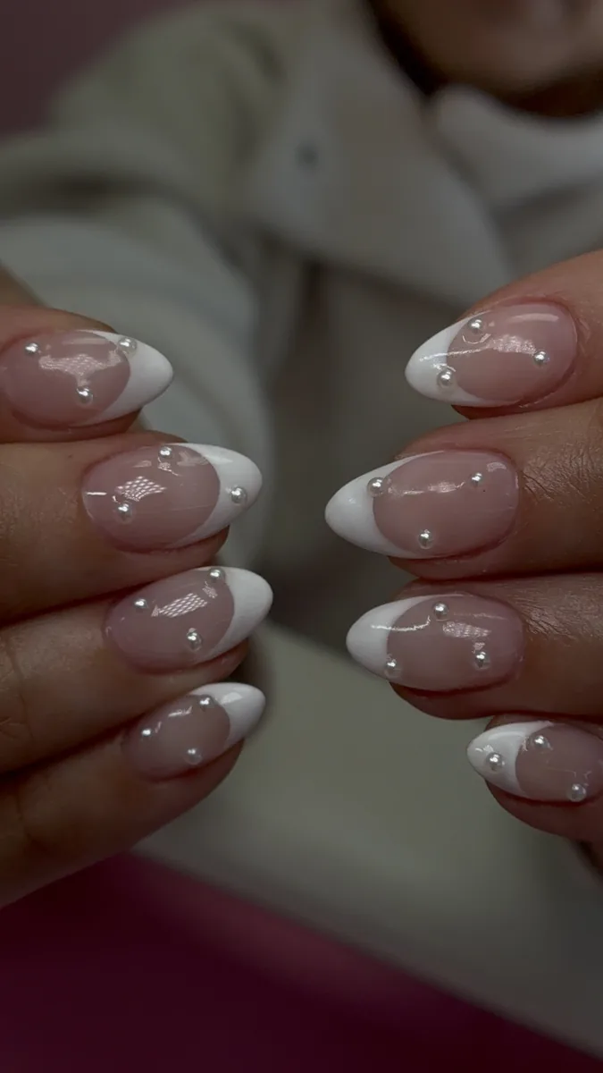 French tip almond nails with pearl shimmer and silver accents on a nude base by Polished by Kim