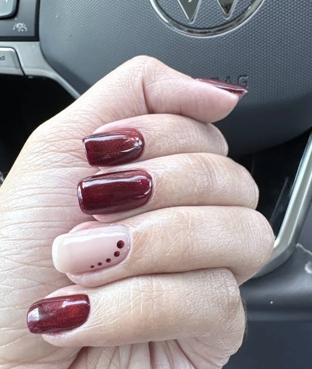 Ashley Alexander's glossy burgundy nail art with a blush accent