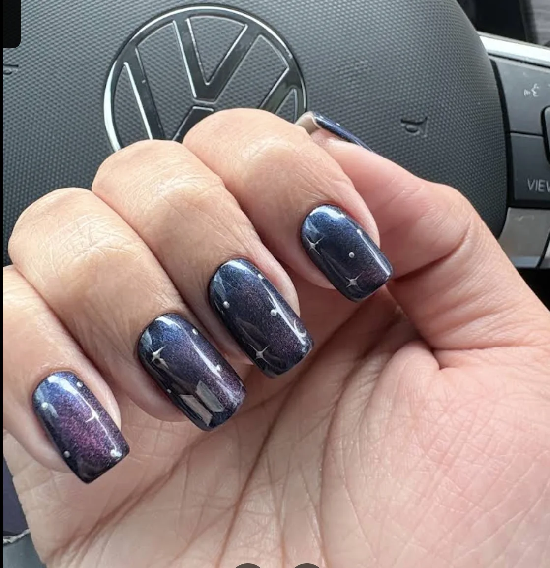 Ashley Alexander's deep blue galaxy nail art with celestial details