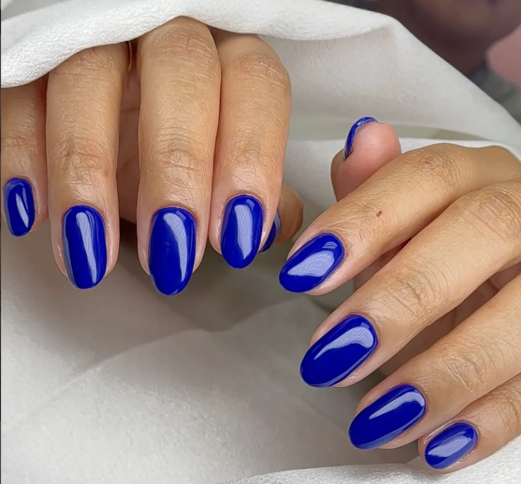 Vibrant royal blue oval gel nails with a high-gloss finish by Polished by Kim