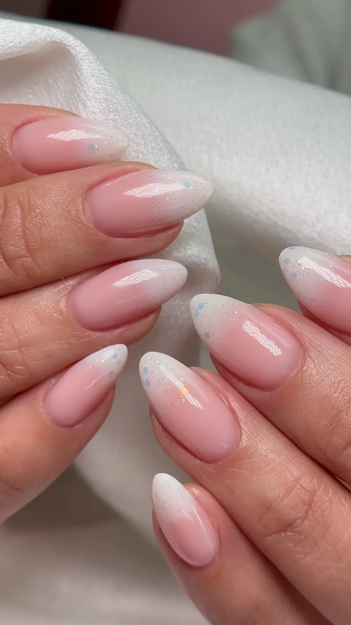 Medium almond nails in a milky glossy finish by Polished by Kim