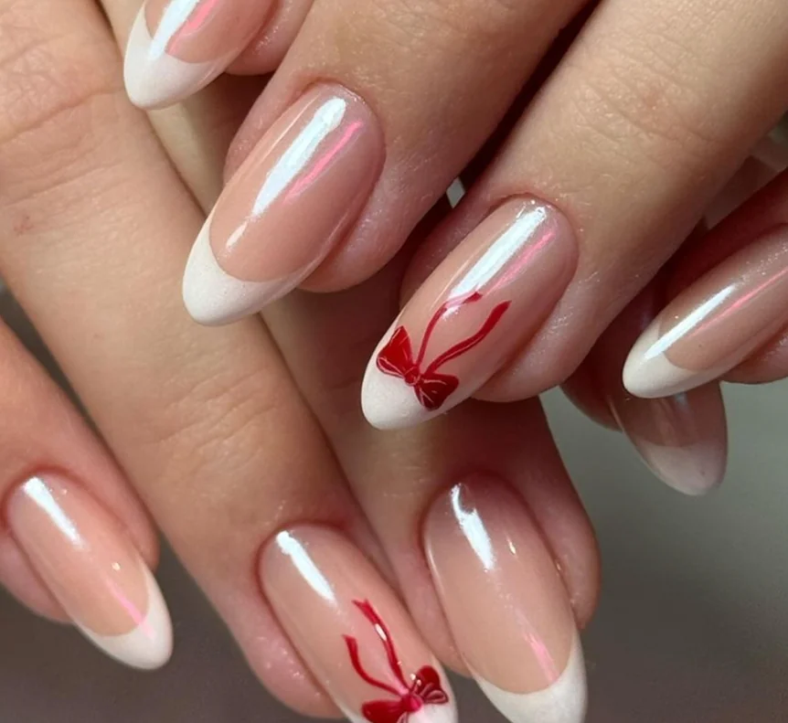 Classic white French tips with red heart accents for Valentine's Day